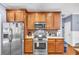 Updated kitchen with stainless steel appliances, wooden cabinets, and a gas range at 4055 Inman Park Ln, Buford, GA 30519
