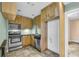 Compact kitchen features stainless steel appliances and wooden cabinets at 4055 Inman Park Ln, Buford, GA 30519