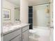 This bathroom features a shower/tub combo, grey cabinets, granite countertops and modern silver hardware at 525 Paces Dr, Lithia Springs, GA 30122