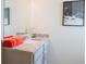 This bathroom has grey cabinets, granite countertops, an orange towel, and silver hardware at 525 Paces Dr, Lithia Springs, GA 30122