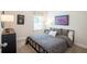 This bedroom has a bed with a patterned comforter, two pieces of art and natural light from a window at 525 Paces Dr, Lithia Springs, GA 30122