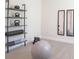 Neutral colored room features fitness equipment, mirrors, weights, shelves, yoga mat, and fitness ball at 525 Paces Dr, Lithia Springs, GA 30122