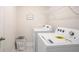 Bright laundry room with new washer and dryer, wire shelving, and laundry basket at 525 Paces Dr, Lithia Springs, GA 30122