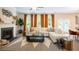 Inviting living room with cozy fireplace, plush sofa, and natural light from large windows at 525 Paces Dr, Lithia Springs, GA 30122