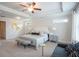 Bright main bedroom features carpet floors, a ceiling fan and a padded bench at 525 Paces Dr, Lithia Springs, GA 30122