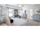 Bright main bedroom featuring a ceiling fan, sitting area, and ensuite bathroom at 525 Paces Dr, Lithia Springs, GA 30122