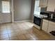 Open kitchen area featuring tile flooring, white cabinets, a black countertop, and an oven at 3155 E East Point E St, East Point, GA 30344