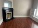 Cozy living room with a decorative fireplace, built-in shelving, and hardwood floors at 3155 E East Point E St, East Point, GA 30344