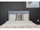 Bedroom close-up featuring accent wall, bed with pillows, and hardwood flooring at 1505 Ezra Church Nw Dr, Atlanta, GA 30314