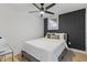 Bedroom featuring contemporary fan, accent wall and queen bed with decorative pillows at 1505 Ezra Church Nw Dr, Atlanta, GA 30314