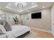 Primary bedroom with tray ceiling, TV, and decorative walls at 1505 Ezra Church Nw Dr, Atlanta, GA 30314