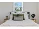 Cozy bedroom featuring white walls, plush bedding, and a large window providing ample natural light at 1505 Ezra Church Nw Dr, Atlanta, GA 30314