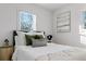 Bright bedroom featuring white walls, plush bedding, and a large window providing ample natural light at 1505 Ezra Church Nw Dr, Atlanta, GA 30314
