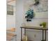 Entryway features light walls, light wood flooring, modern art, and decor accents atop a console table at 1505 Ezra Church Nw Dr, Atlanta, GA 30314