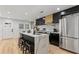 Open kitchen featuring stainless steel appliances, island seating, quartz countertops, and wood floors at 1505 Ezra Church Nw Dr, Atlanta, GA 30314