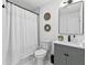 Elegant bathroom features a shower-tub combination and a gray vanity at 1566 Ezra Church Nw Dr, Atlanta, GA 30314