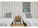 Modern bedroom features two twin beds, patterned wallpaper, and updated lighting at 1566 Ezra Church Nw Dr, Atlanta, GA 30314