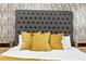Stylish bedroom features a gray tufted headboard and bedside tables at 1566 Ezra Church Nw Dr, Atlanta, GA 30314