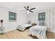 Bedroom showcasing two twin beds, geometric wallpaper, wood flooring, and a ceiling fan at 1566 Ezra Church Nw Dr, Atlanta, GA 30314
