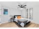 Bedroom featuring patterned wallpaper, a ceiling fan, and a Queen bed with orange pillows at 1566 Ezra Church Nw Dr, Atlanta, GA 30314