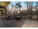 Large deck featuring wood flooring, modern seating, and scenic trees at 1566 Ezra Church Nw Dr, Atlanta, GA 30314