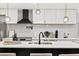 Contemporary kitchen featuring white cabinets, modern lighting, and stainless steel appliances at 1566 Ezra Church Nw Dr, Atlanta, GA 30314