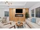 Bright living room with decorative fireplace and mantle, light wood floors and neutral decor at 1566 Ezra Church Nw Dr, Atlanta, GA 30314