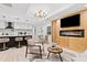 Open-concept living area featuring a modern fireplace, kitchen, dining and hardwood floors at 1566 Ezra Church Nw Dr, Atlanta, GA 30314
