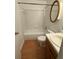 Bathroom featuring a toilet, bathtub, shower, vanity, and round mirror at 2340 Beaver Ruin Rd # Un37, Norcross, GA 30071
