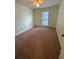 Standard bedroom with carpet, ceiling fan, and natural light from window at 2340 Beaver Ruin Rd # Un37, Norcross, GA 30071