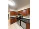 Well-lit kitchen features stainless steel appliances, tile floors and wooden cabinets at 2340 Beaver Ruin Rd # Un37, Norcross, GA 30071