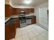 Well-lit kitchen features stainless steel appliances, tile floors and wooden cabinets at 2340 Beaver Ruin Rd # Un37, Norcross, GA 30071