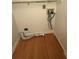 An angled laundry room with light hardwood floors and laundry hookups at 2340 Beaver Ruin Rd # Un37, Norcross, GA 30071