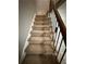 Staircase with neutral carpet and dark wrought iron railing at 2340 Beaver Ruin Rd # Un37, Norcross, GA 30071
