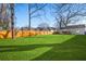 Expansive backyard features lush green lawn, bordered by a wood fence and mature trees, offering a private outdoor space at 749 Bonnie Brae Sw Ave, Atlanta, GA 30310
