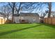 Well-manicured backyard with a charming deck, enclosed by a wooden fence for privacy and a lush lawn at 749 Bonnie Brae Sw Ave, Atlanta, GA 30310
