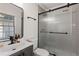Well-lit bathroom featuring a shower with a frosted glass door, modern vanity, and black hardware at 749 Bonnie Brae Sw Ave, Atlanta, GA 30310