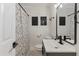 Stylish bathroom with a black and white shower curtain, modern vanity, and sleek fixtures at 749 Bonnie Brae Sw Ave, Atlanta, GA 30310