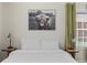 Bedroom featuring crisp white linens, two side tables with lamps, and decorative art at 749 Bonnie Brae Sw Ave, Atlanta, GA 30310
