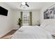 Bright bedroom featuring hardwood floors, decorative art, ceiling fan, and neutral walls at 749 Bonnie Brae Sw Ave, Atlanta, GA 30310