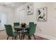 Cozy dining area features a round table with green chairs and modern art, creating an inviting atmosphere at 749 Bonnie Brae Sw Ave, Atlanta, GA 30310