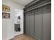 Hallway with shelving and hooks leads to a bathroom featuring a gray vanity at 749 Bonnie Brae Sw Ave, Atlanta, GA 30310