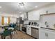 Open-concept kitchen featuring stainless steel appliances, white cabinetry, and a view to the living room at 749 Bonnie Brae Sw Ave, Atlanta, GA 30310