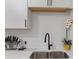 Close up of sink and faucet with white subway tile back splash and white cabinets at 749 Bonnie Brae Sw Ave, Atlanta, GA 30310