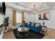 Stylish living room features a blue sectional, fireplace, modern decor, and bright window with vibrant curtains at 749 Bonnie Brae Sw Ave, Atlanta, GA 30310