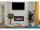 A cozy fireplace with a television above, alongside a comfortable seating area with bright window accents at 749 Bonnie Brae Sw Ave, Atlanta, GA 30310