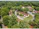 Aerial view of a tree-filled community with homes and parked cars at 502 Bridge Se Ln, Smyrna, GA 30082