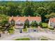 Aerial view of townhomes and parking lot surrounded by green trees at 502 Bridge Se Ln, Smyrna, GA 30082
