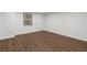 Finished basement with modern laminate flooring, a window, and a white door at 502 Bridge Se Ln, Smyrna, GA 30082