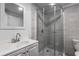 Bathroom featuring a corner shower with glass doors, a toilet, and a vanity with sink at 502 Bridge Se Ln, Smyrna, GA 30082